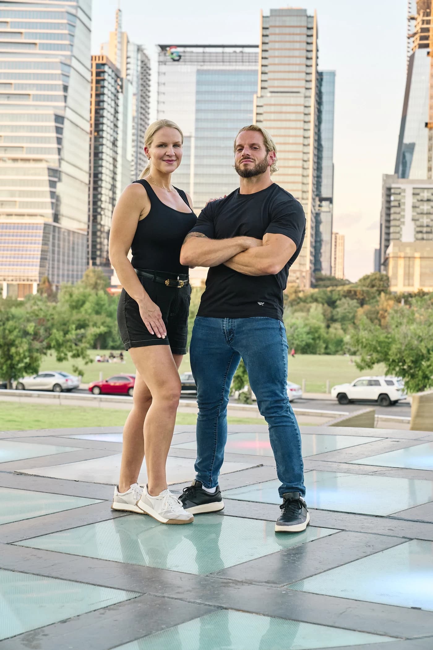 Jarred and Katelyn Curcio standing together with the Austin skyline behind them