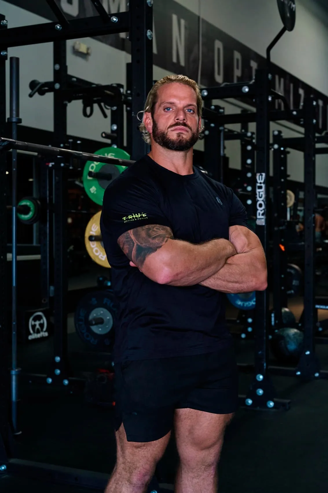 Jarred Curcio standing with arms crossed in the gym in Austin, Texas