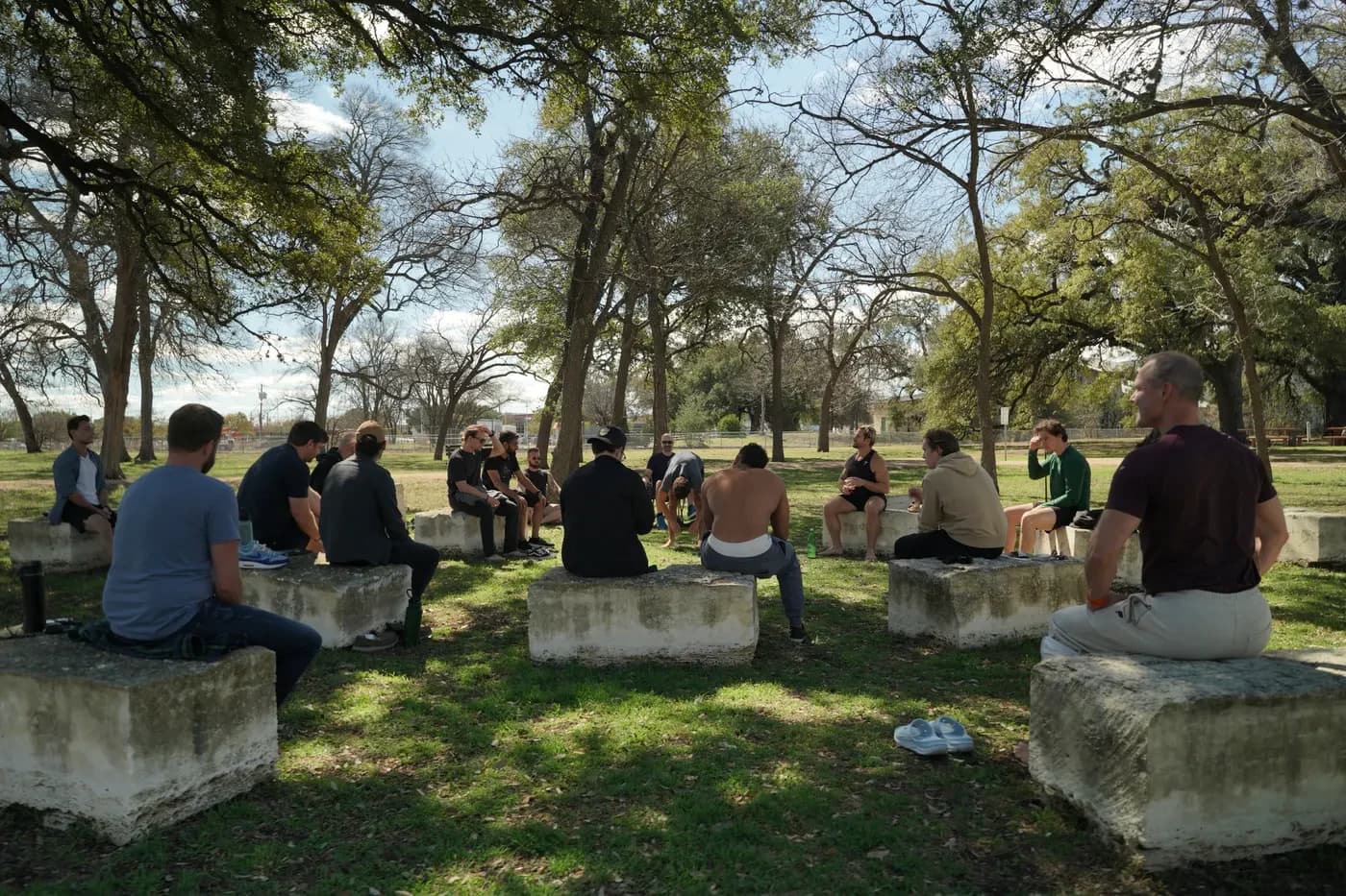 The Stoic Sundays group seated on the stone circle under the trees in Austin, Texas