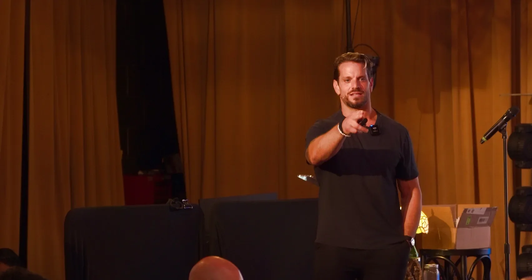 Jarred Curcio pointing from the stage at The Focus Lab in Austin, Texas