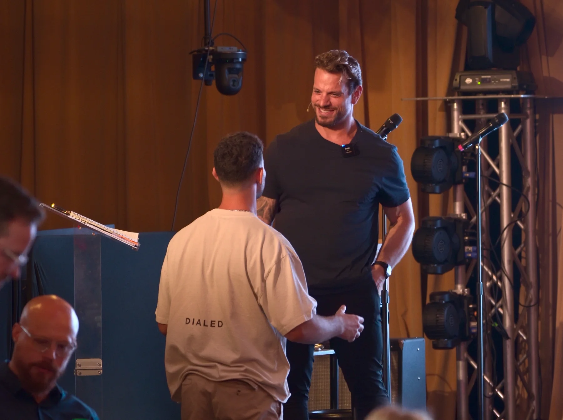 Jarred Curcio on stage at The Focus Lab greeting an attendee in Austin, Texas