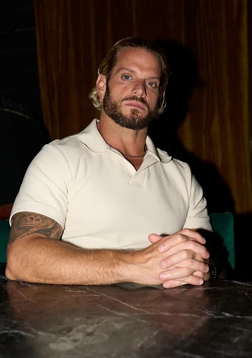 Jarred Curcio seated at a desk in a contemplative moment in Austin, Texas