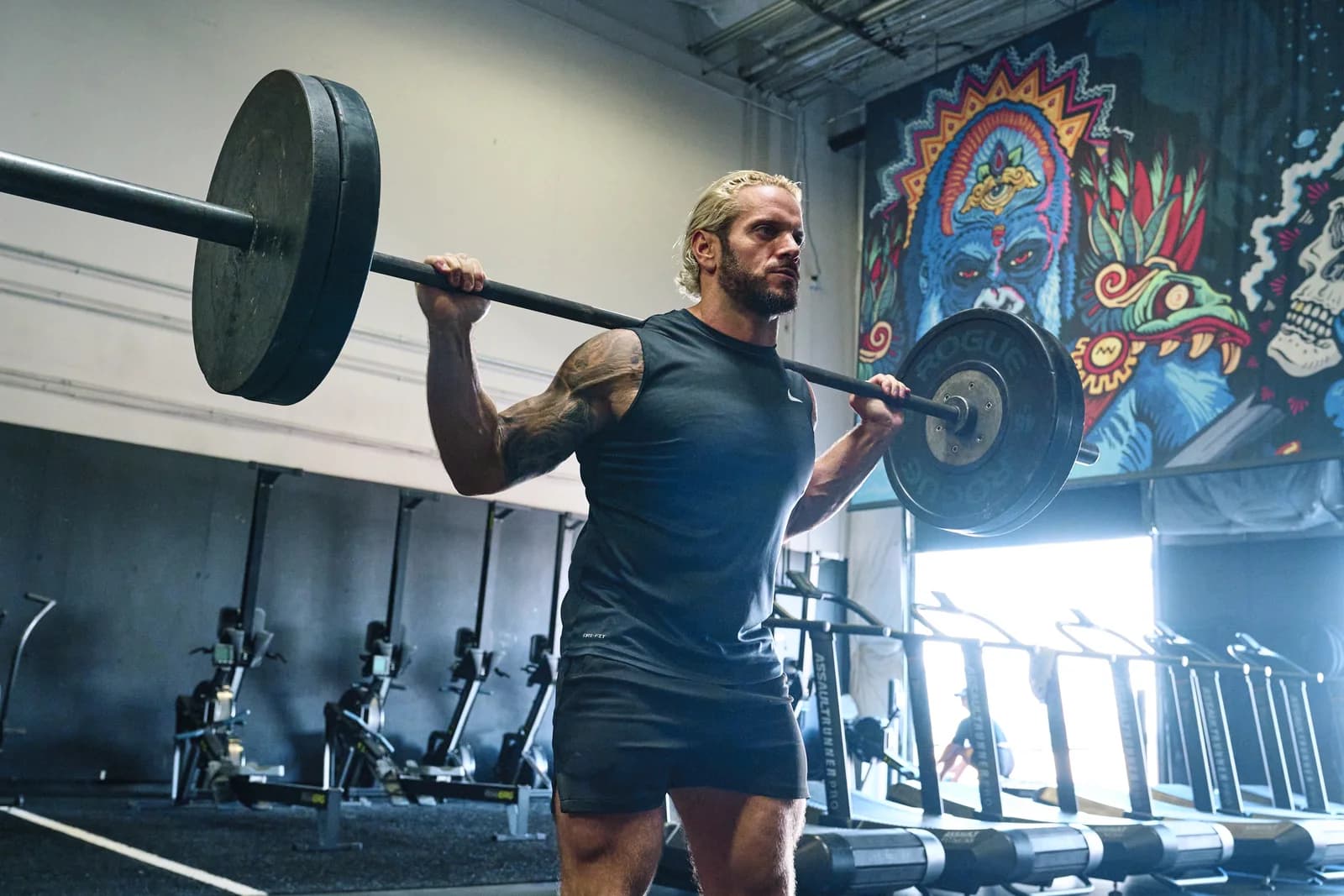 Jarred Curcio pressing a barbell overhead during a training session in Austin